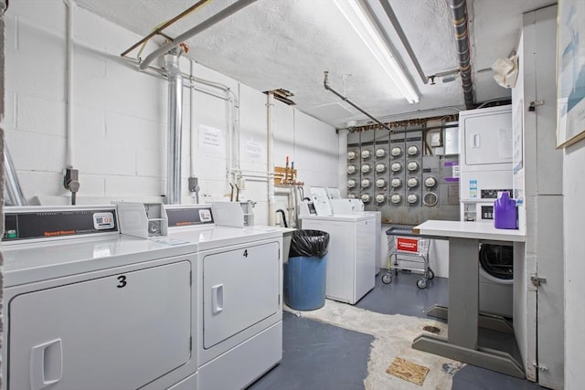 community laundry with separate washer and dryer and stacked washing machine and dryer