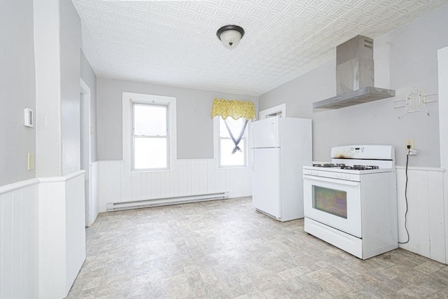 kitchen featuring an ornate ceiling, a wainscoted wall, baseboard heating, wall chimney range hood, and white appliances