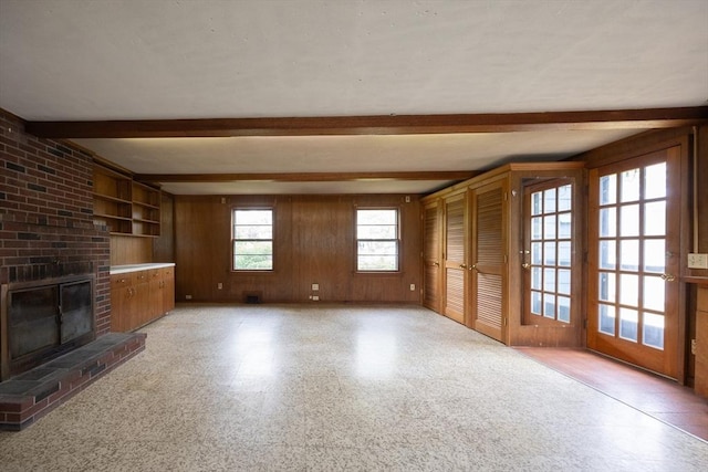 23 Crescent Ave, North Attleboro, MA 02760 - unfurnished living room featuring beamed ceiling, wood walls, and a fireplace