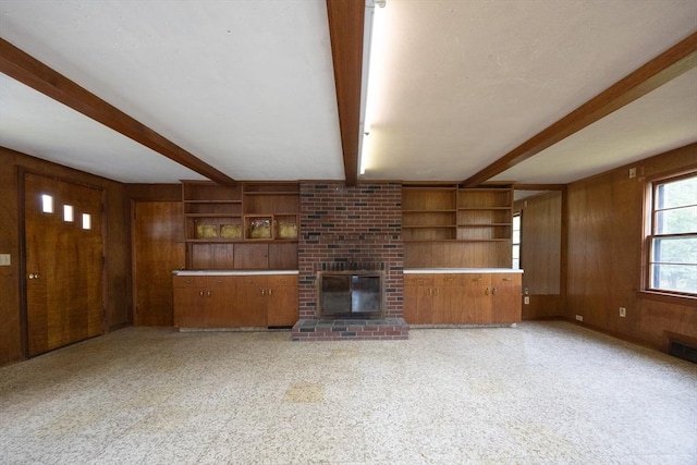 23 Crescent Ave, North Attleboro, MA 02760 - unfurnished living room with wooden walls, beam ceiling, a brick fireplace, and built in features