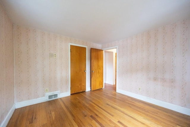 23 Crescent Ave, North Attleboro, MA 02760 - empty room with wood finished floors and wallpapered walls