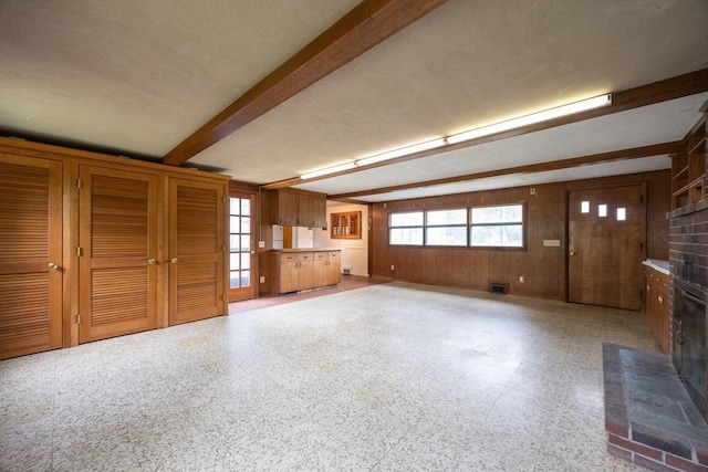 23 Crescent Ave, North Attleboro, MA 02760 - unfurnished living room featuring beam ceiling, a brick fireplace, and wooden walls