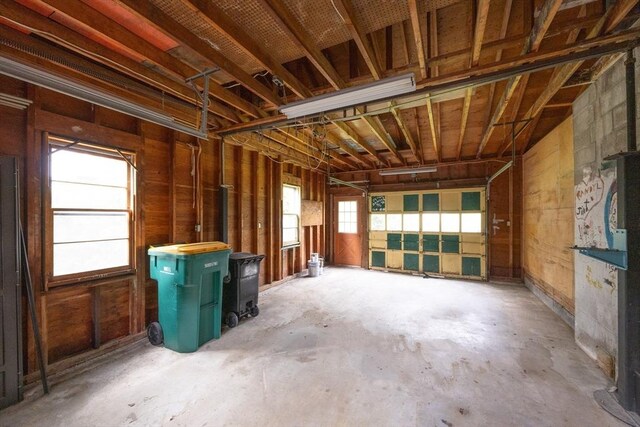 23 Crescent Ave, North Attleboro, MA 02760 - miscellaneous room featuring a garage, unfinished concrete floors, and a wood stove