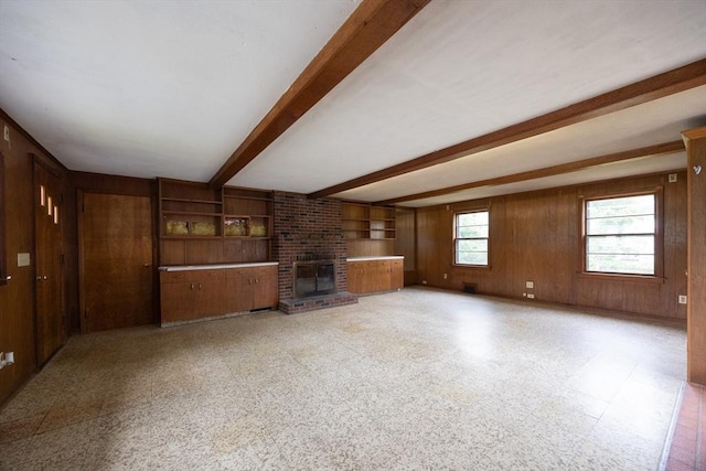 23 Crescent Ave, North Attleboro, MA 02760 - unfurnished living room featuring beam ceiling, wood walls, and a brick fireplace