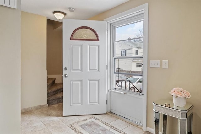 doorway to outside with stairway, light tile patterned flooring, and baseboards