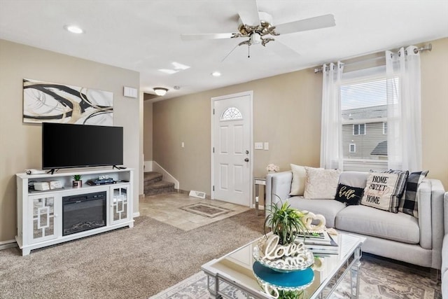 carpeted living room with stairs, baseboards, a ceiling fan, and recessed lighting