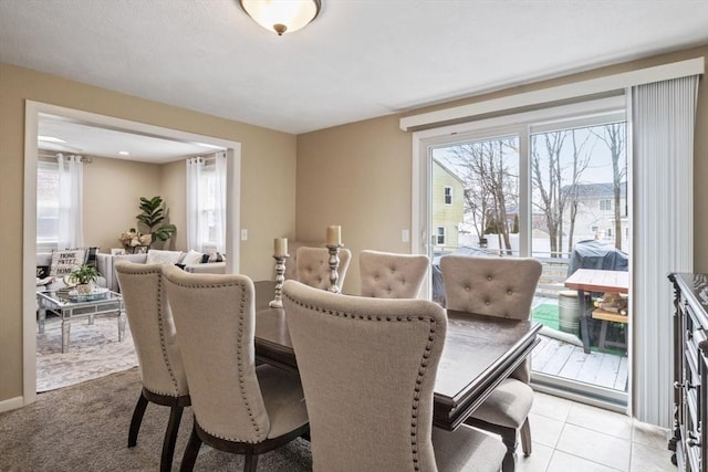 dining area with light tile patterned flooring and a wealth of natural light