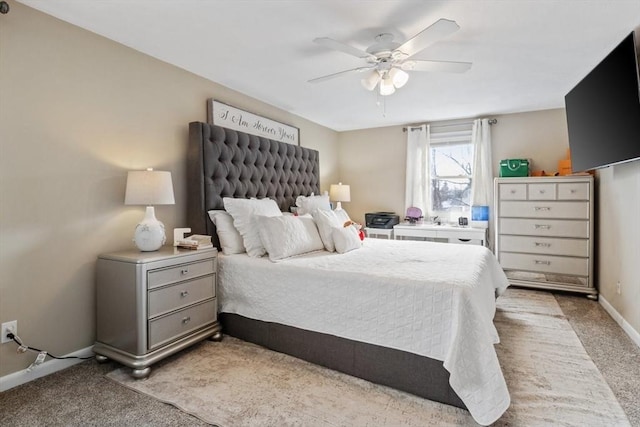 bedroom with light colored carpet, ceiling fan, and baseboards