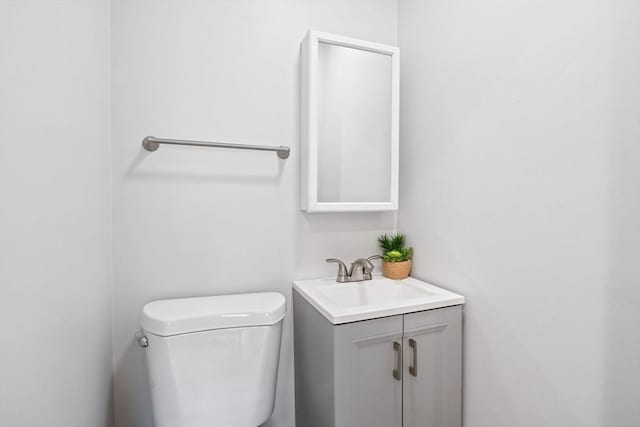 half bath featuring toilet and vanity