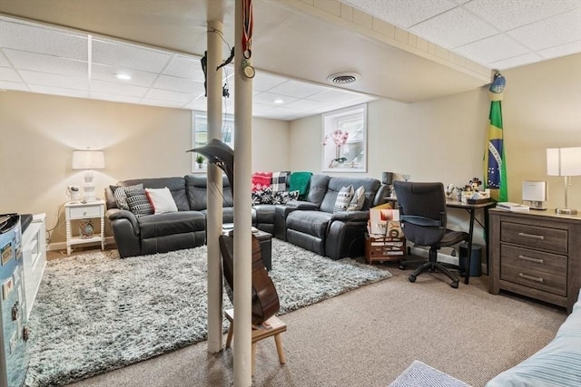 living room featuring a paneled ceiling, plenty of natural light, carpet, and visible vents