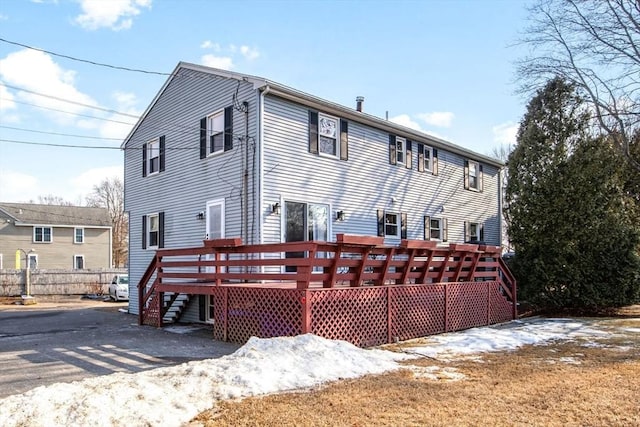 back of property featuring a wooden deck