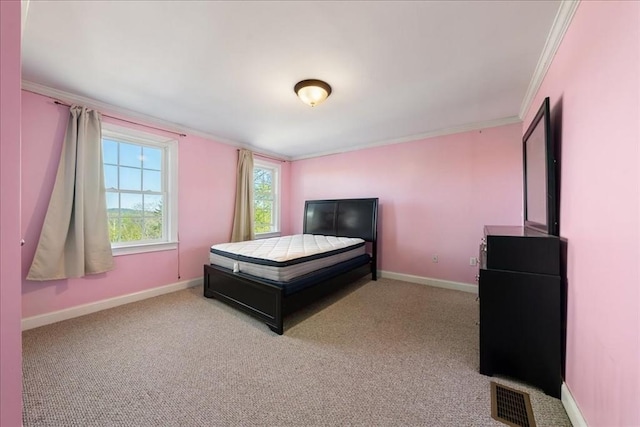 carpeted bedroom with visible vents, ornamental molding, and baseboards