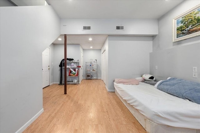 bedroom with visible vents, recessed lighting, and wood finished floors