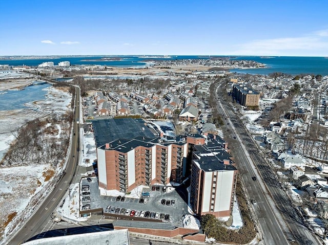 snowy aerial view with a water view