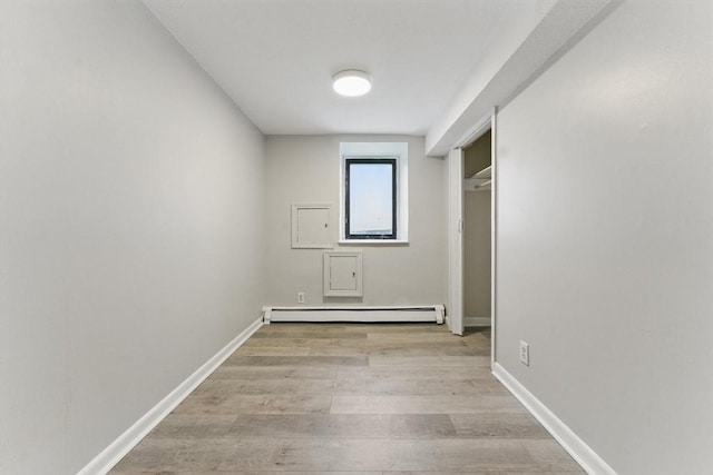 57 Brighton Ave Unit A, Boston, MA 02134 - unfurnished bedroom featuring baseboard heating, light wood finished floors, baseboards, and a closet