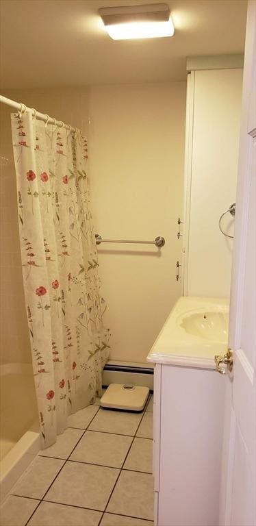 full bathroom with a baseboard radiator, tile patterned floors, vanity, and shower / tub combo with curtain
