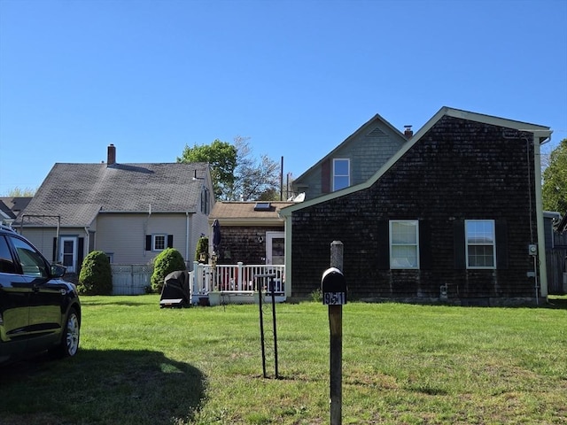 view of front of house with a front lawn and a wooden deck