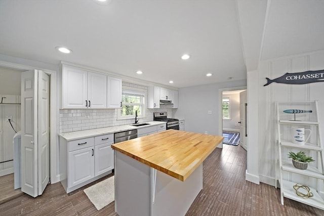 323 N Main St, Cohasset, MA 02025 - kitchen featuring stainless steel appliances, a sink, white cabinetry, tasteful backsplash, and healthy amount of natural light