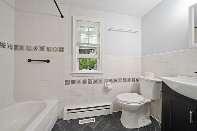 323 N Main St, Cohasset, MA 02025 - bathroom with tile walls, baseboard heating, vanity, toilet, and a wainscoted wall