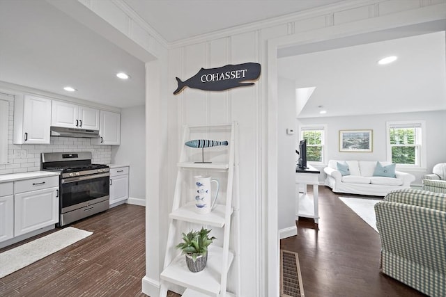 323 N Main St, Cohasset, MA 02025 - kitchen with gas stove, under cabinet range hood, white cabinets, light countertops, and recessed lighting