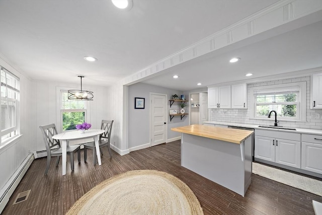323 N Main St, Cohasset, MA 02025 - kitchen with a sink, butcher block counters, white cabinetry, tasteful backsplash, and dark wood finished floors