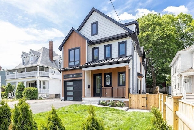 1597 Centre St Unit 2, Newton, MA 02461 - view of front of home featuring covered porch, a standing seam roof, asphalt driveway, an attached garage, and metal roof
