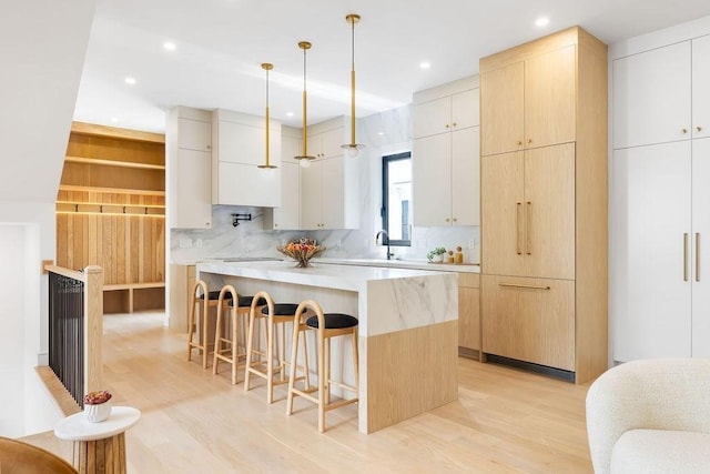 1597 Centre St Unit 2, Newton, MA 02461 - kitchen featuring a kitchen breakfast bar, modern cabinets, a sink, and recessed lighting