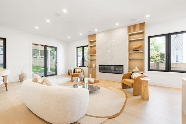 1597 Centre St Unit 2, Newton, MA 02461 - living room featuring recessed lighting, baseboards, built in shelves, light wood-style flooring, and a fireplace