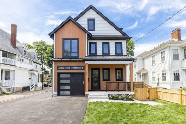 1597 Centre St Unit 2, Newton, MA 02461 - view of front of home featuring a porch, a standing seam roof, driveway, an attached garage, and metal roof