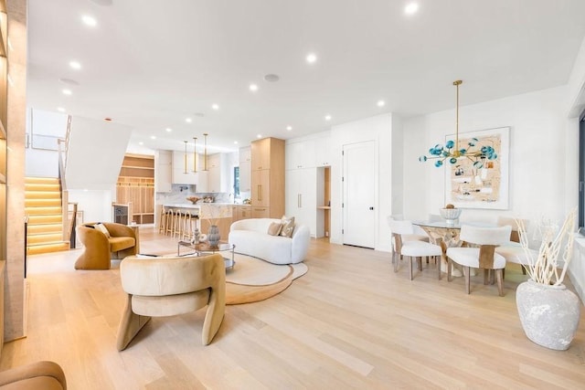 1597 Centre St Unit 2, Newton, MA 02461 - living room with light wood-type flooring, stairway, and recessed lighting