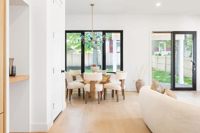 1597 Centre St Unit 2, Newton, MA 02461 - dining space with healthy amount of natural light, light wood-style floors, baseboards, a chandelier, and recessed lighting