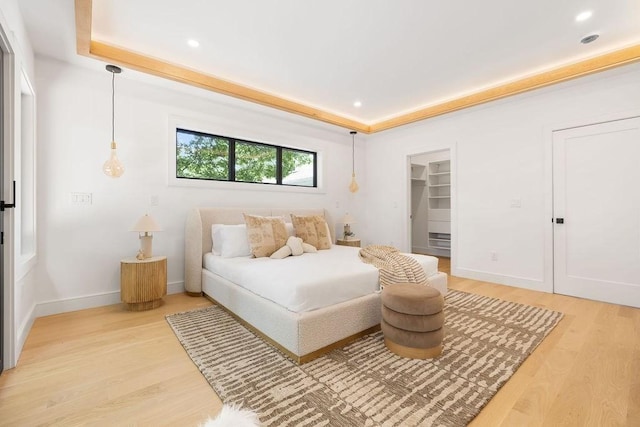 1597 Centre St Unit 2, Newton, MA 02461 - bedroom with light wood-style flooring, recessed lighting, a tray ceiling, and baseboards