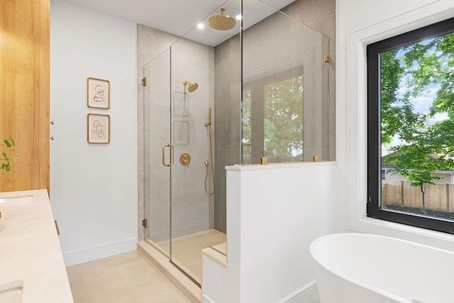 1597 Centre St Unit 2, Newton, MA 02461 - bathroom with a stall shower, a freestanding bath, vanity, and baseboards