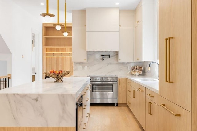 1597 Centre St Unit 2, Newton, MA 02461 - kitchen featuring stainless steel electric range, a sink, backsplash, light stone counters, and recessed lighting