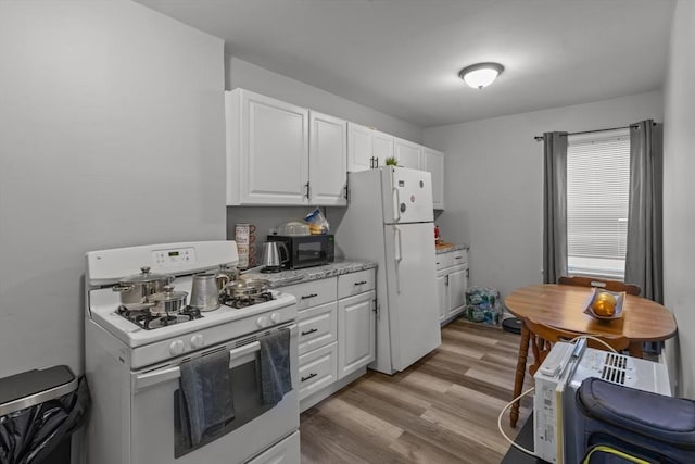 kitchen featuring white cabinets, white appliances, and light hardwood / wood-style flooring