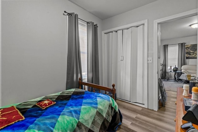 bedroom with a closet and light hardwood / wood-style floors