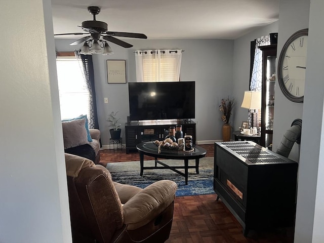 living room with ceiling fan and dark parquet flooring