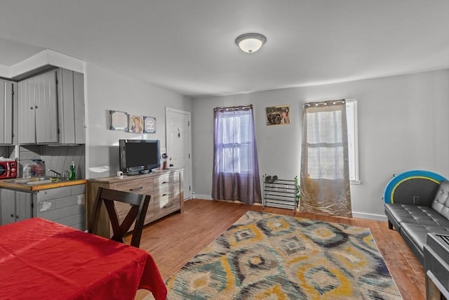 bedroom with sink and light wood-type flooring