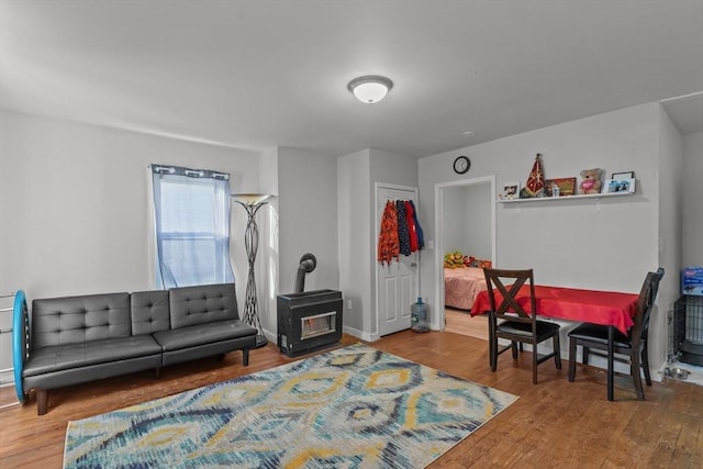 interior space featuring a wood stove and hardwood / wood-style floors