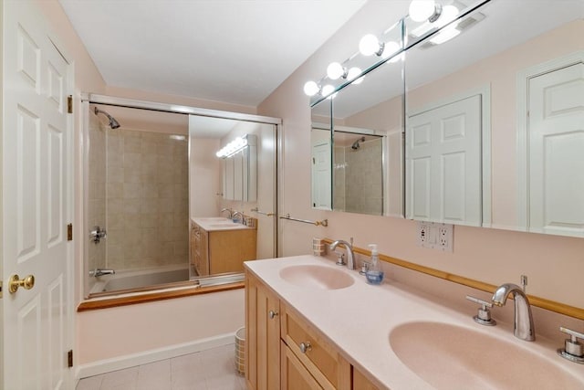 bathroom with combined bath / shower with glass door, double vanity, and tile patterned flooring