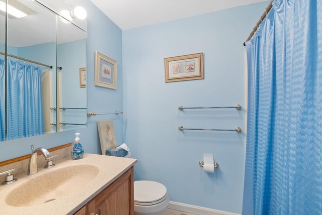 full bathroom featuring toilet, vanity, and a shower with shower curtain