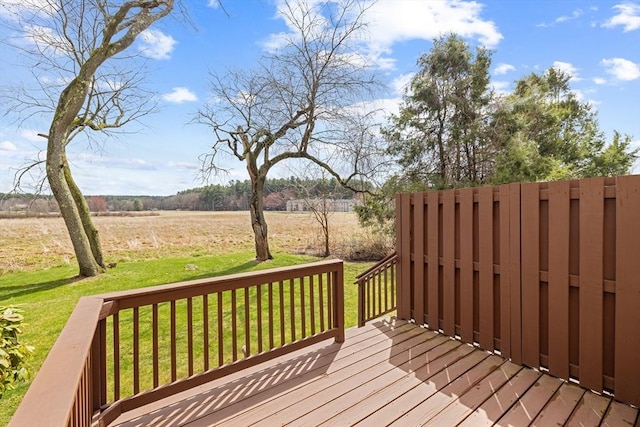 deck with a yard and a view of rural / pastoral area