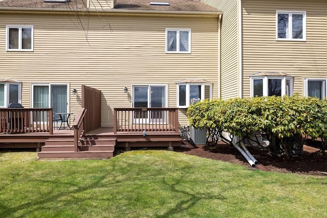 rear view of house featuring a yard and a wooden deck
