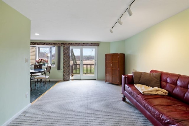 living room featuring rail lighting, baseboards, carpet, and recessed lighting