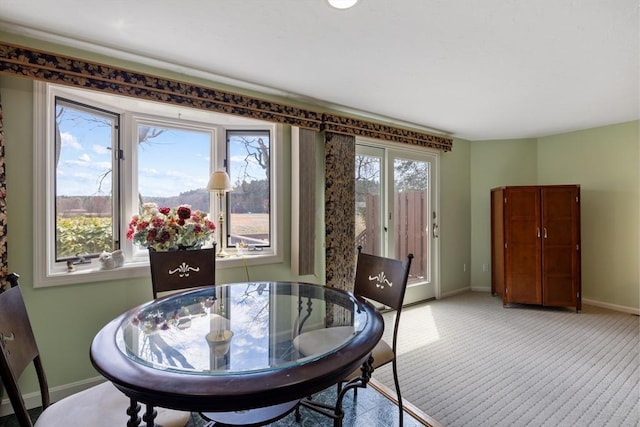 dining area with baseboards and carpet flooring
