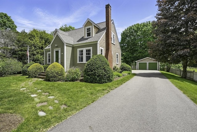 247 S St, Wrentham, MA 02093 - view of front facade with a detached garage, an outbuilding, a chimney, and roof with shingles