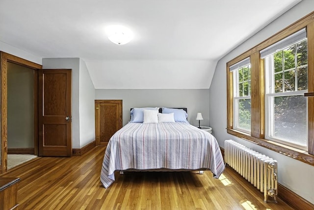 247 S St, Wrentham, MA 02093 - bedroom with radiator heating unit, light wood-style flooring, lofted ceiling, and baseboards