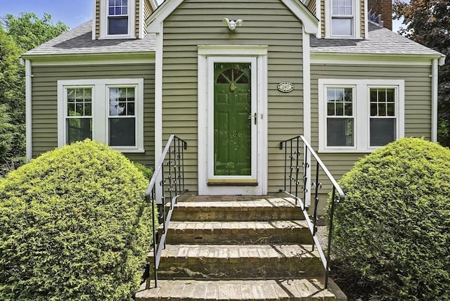 247 S St, Wrentham, MA 02093 - doorway to property featuring roof with shingles and a chimney