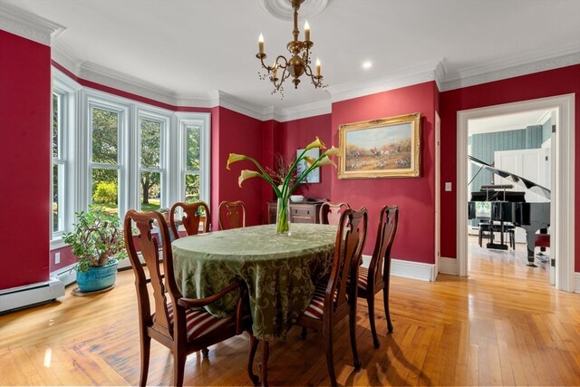 dining space featuring crown molding, light hardwood / wood-style flooring, and an inviting chandelier