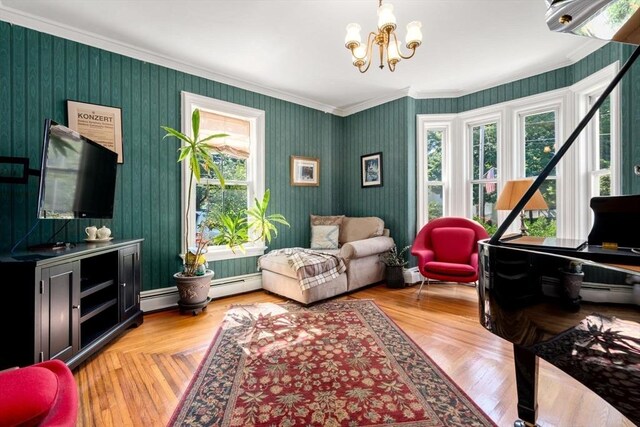 sitting room featuring crown molding, a baseboard radiator, a notable chandelier, and light hardwood / wood-style floors